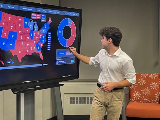 Nick beside an election results display.